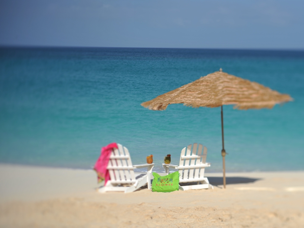 Two beach chairs on a white sand beach in The Bahamas