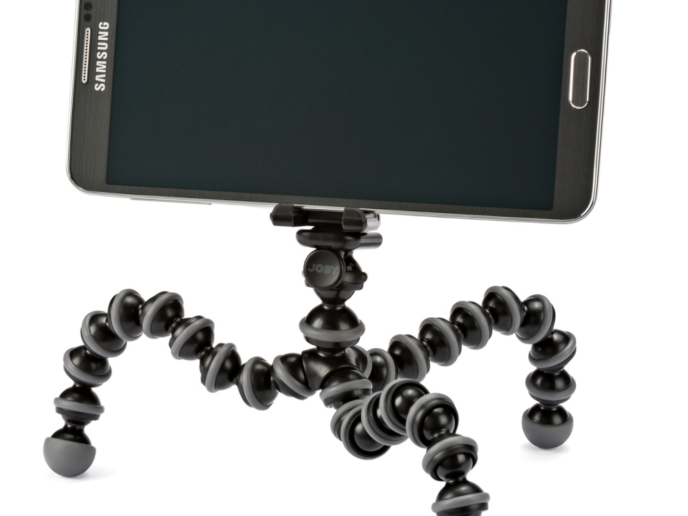 A mobile phone attached to a Joby tripod.