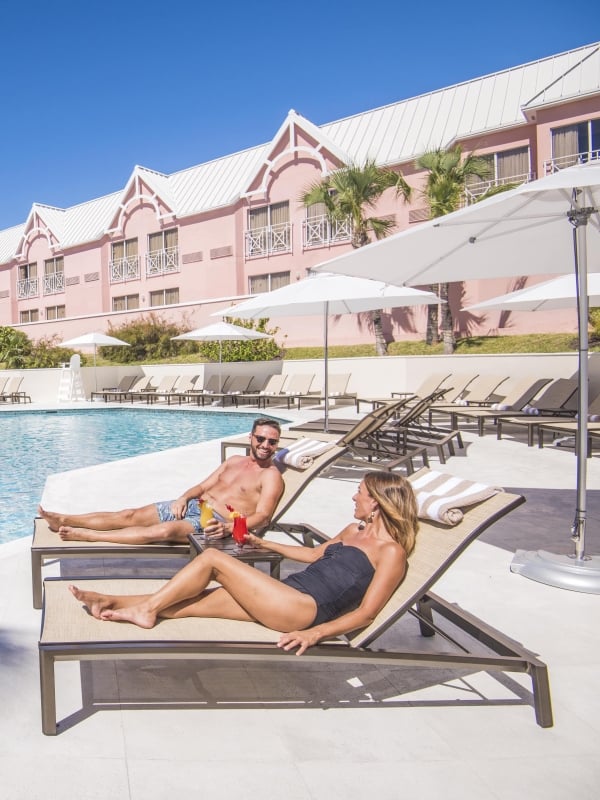 A couple on lounge chairs at Comfort Suites in Nassau Paradise Island