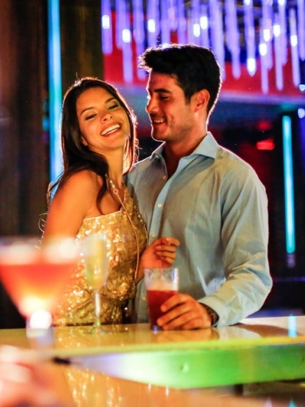 A couple having a cocktail at Aura Nightclub