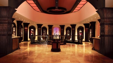 A beautiful open room with dark wooden detailed pillars.