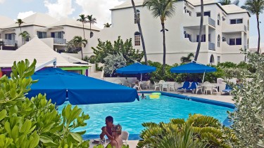 A lush pool area of a tropical resort.