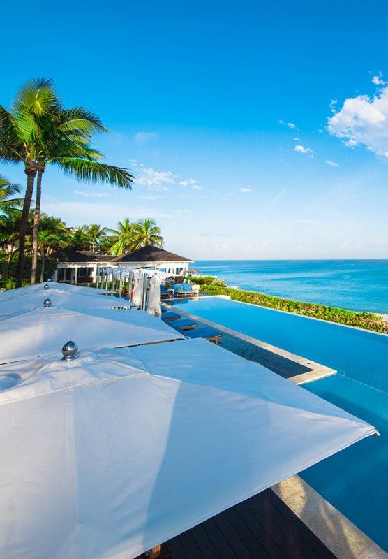 An infinity pool with stunning views of turquoise tropical waters.