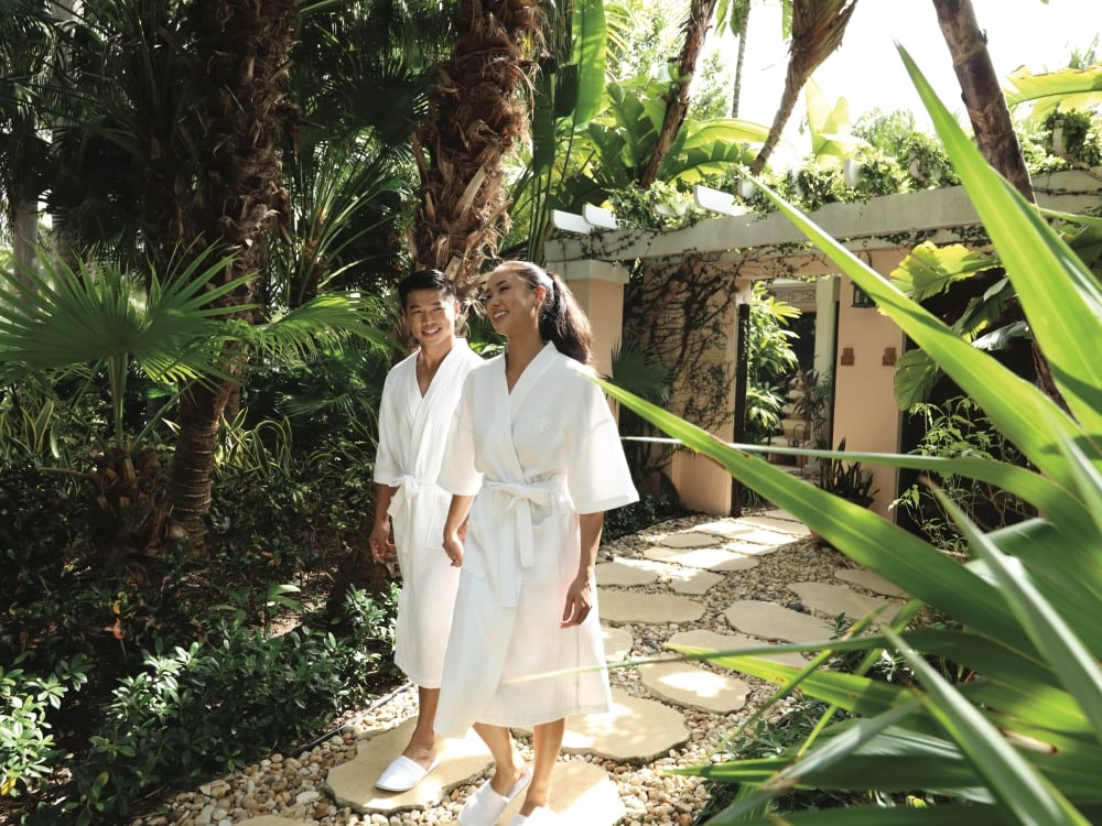 A couple walking in robes in Nassau Paradise Island