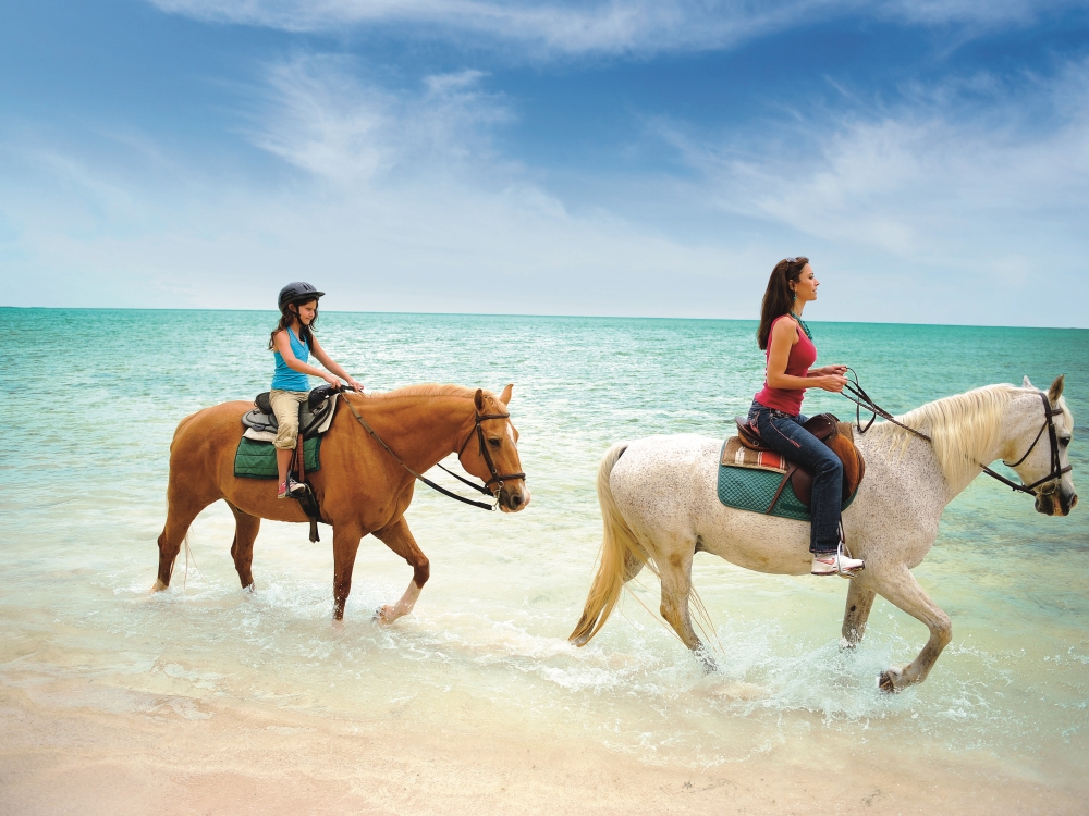 A mother and daughter horseback riding in Nassau