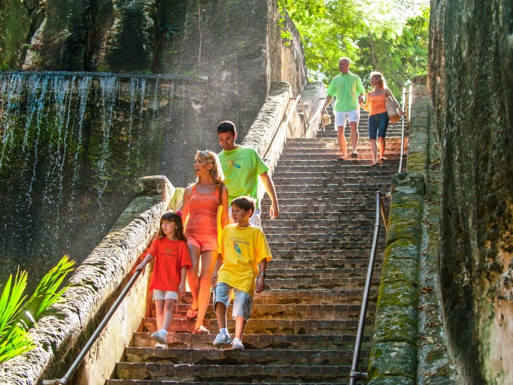 A family walking down Queen's Staircase in The Bahamas