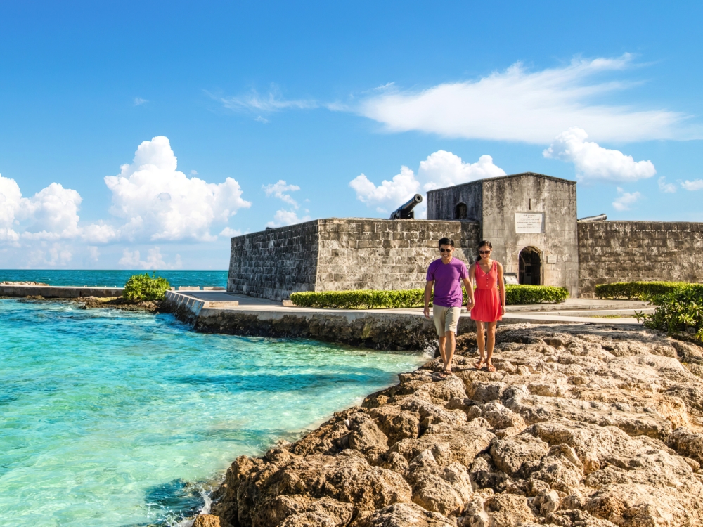 A couple walking near a fort in Nassau Paradise Island