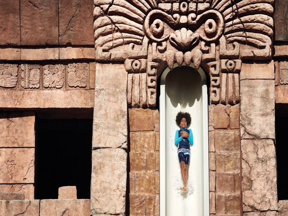 A boy sliding at Aquaventure at Atlantis Paradise Island