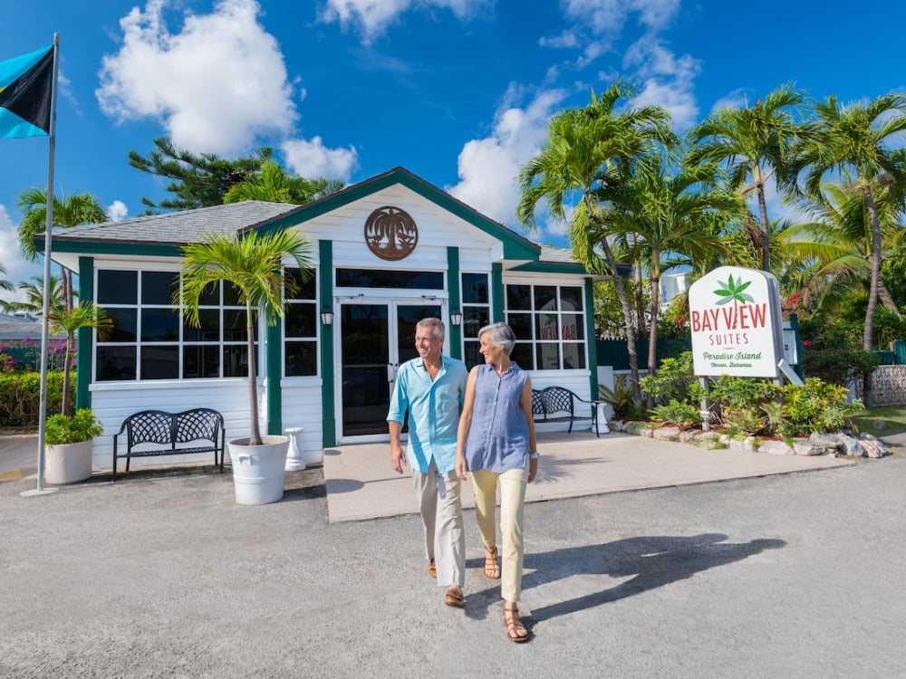 A couple walking out of Bayview Suites Paradise Island, Bahamas