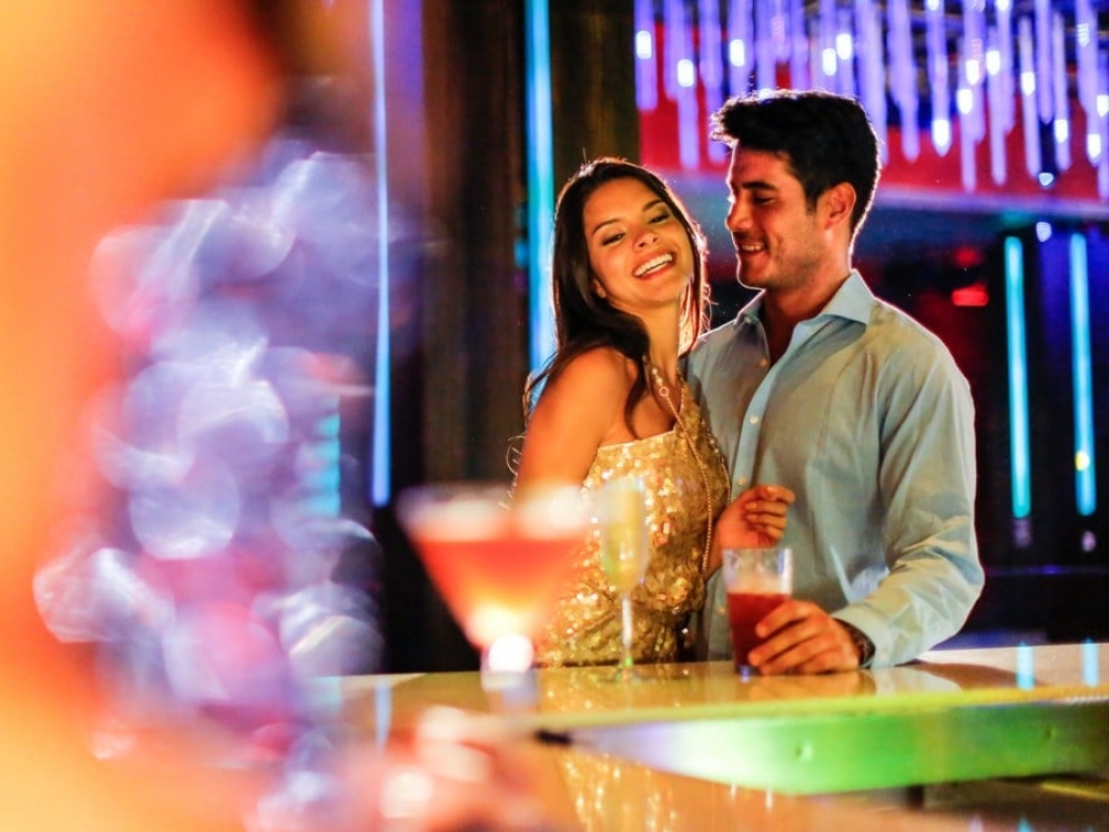 A couple having a cocktail at Aura Nightclub