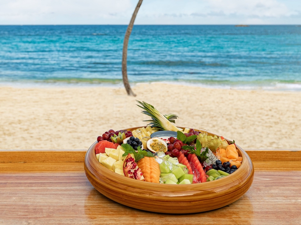 Frezca at Atlantis Paradise Island, a fruit platter on a bar in front of the ocean