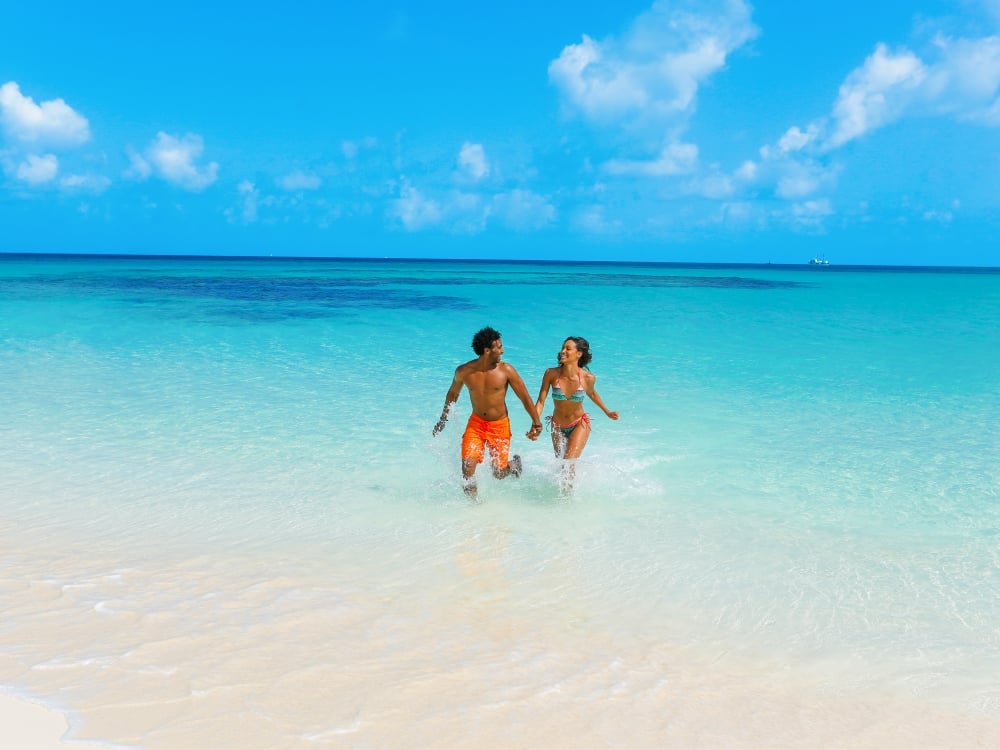 A couple in the water on the beach in Nassau