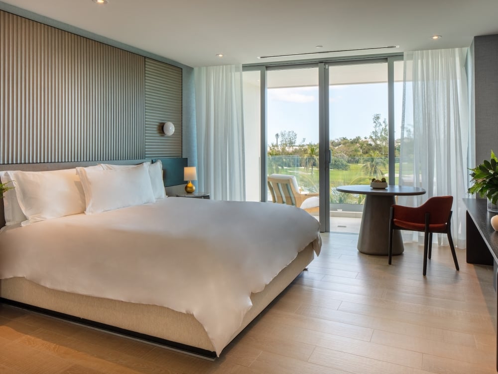 large bedroom with floor to ceiling windows