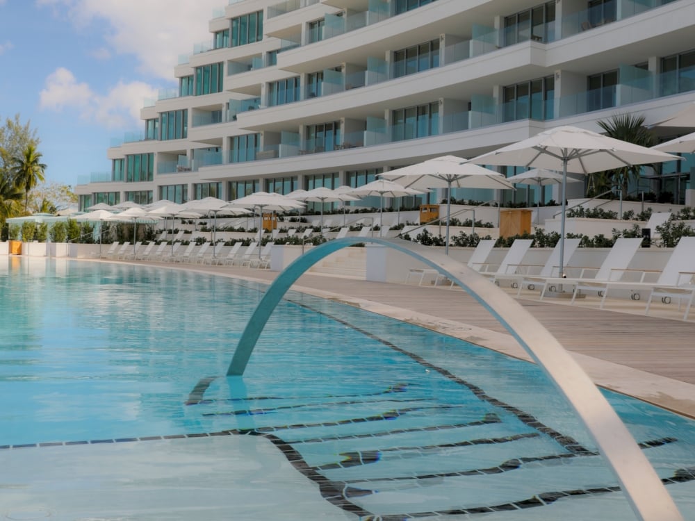 large pool with resort in the background