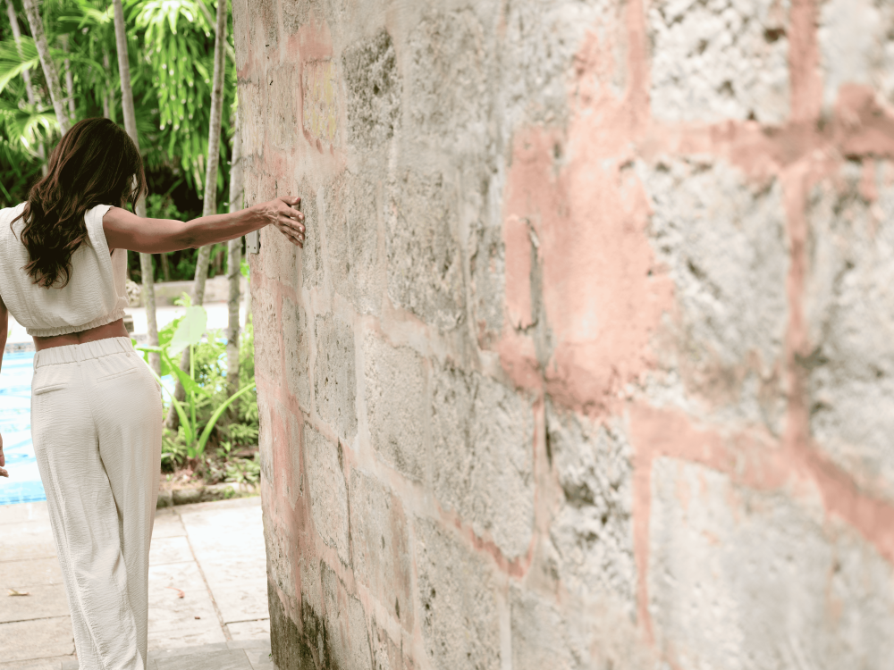 woman touching old wall