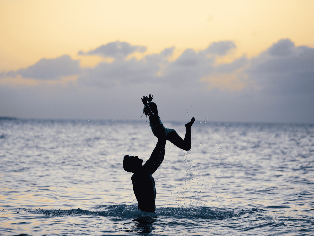 dad and daughter playing in the water
