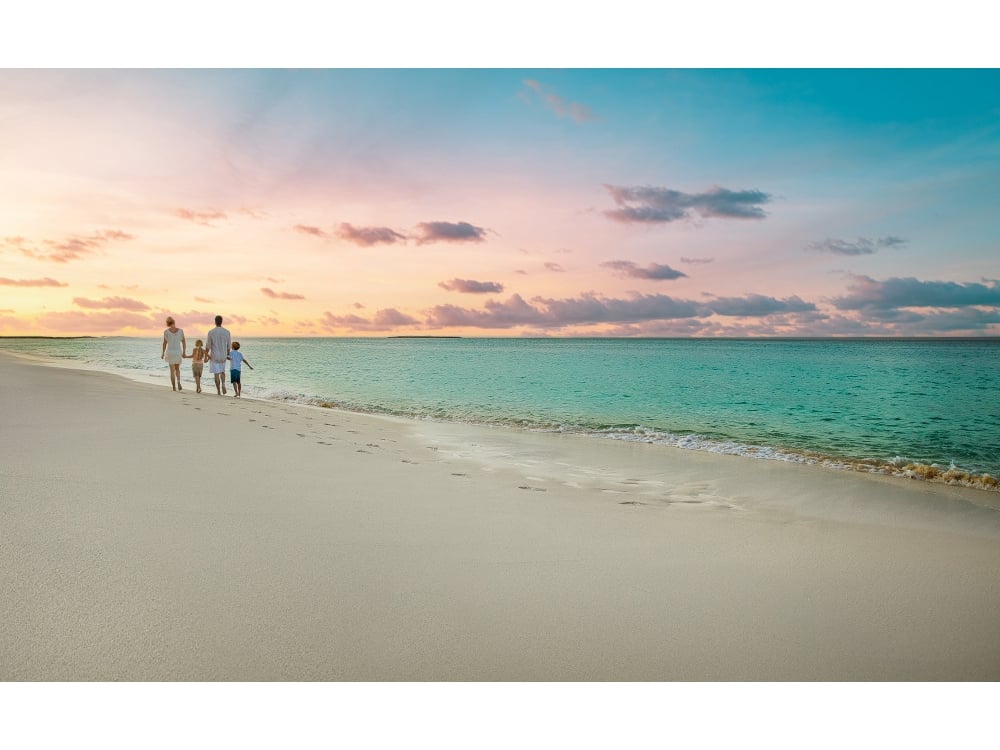 family walking on the beach