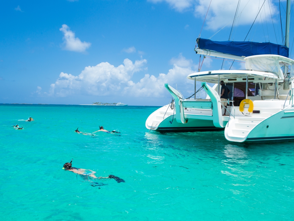 Catamaran boat with people snorkeling