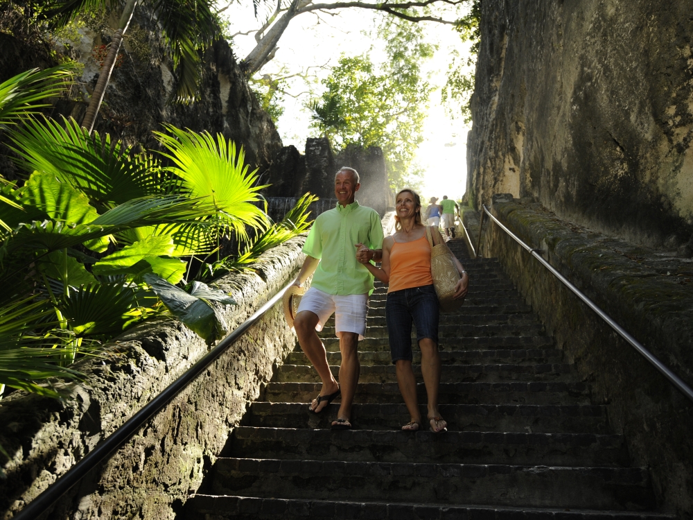 A senior couple descends the Queen's Staircase in Nassau, Bahamas.