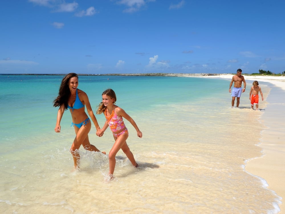 Family on a beach in Nassau Paradise Island, The Bahamas