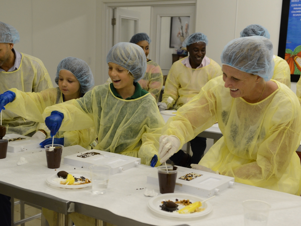 A family sits making their own chocolate treats at Graycliff Chocolatier