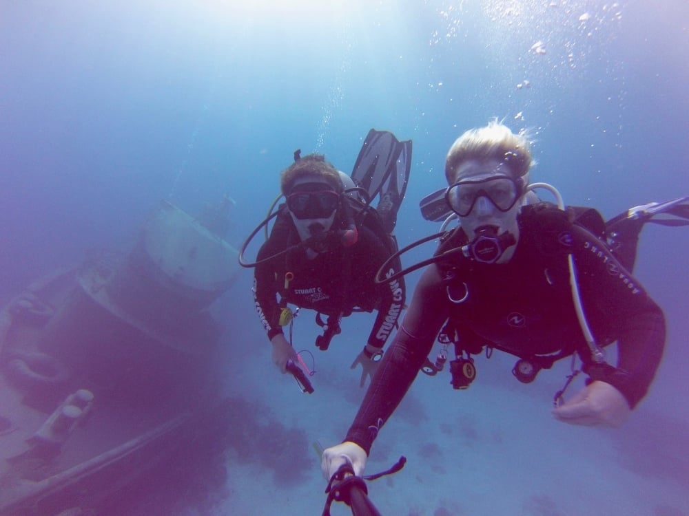 Two scuba divers explore a wreck in The Bahamas