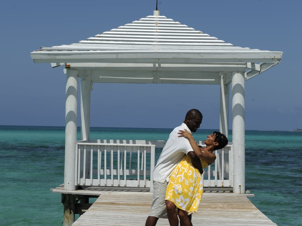 A couple dances on a boardwalk in The Bahamas