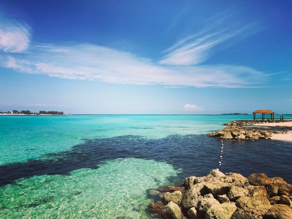 Clear turquoise water and a beautiful blue sky at Cable Beach in The Bahamas.