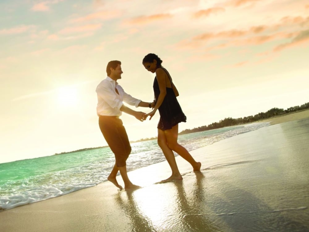A couple dancing on the beach in Baha Mar