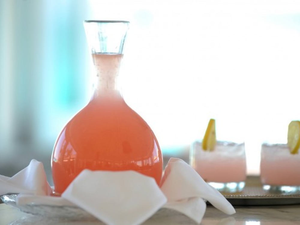 A carafe and two glasses of a Bahamian cocktail. 