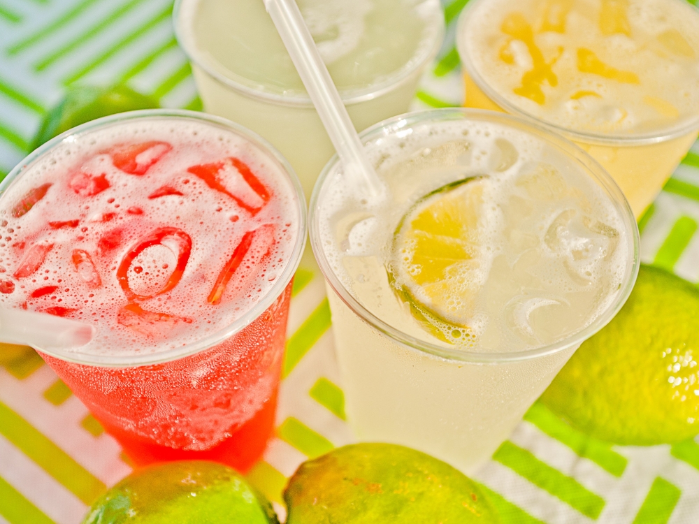 Colorful tropical drinks and sliced limes