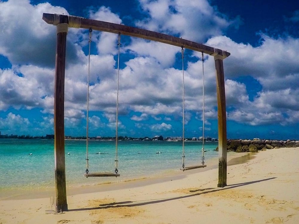 A rustic swingset for two on a beach at Sandals Royal Bahamian all-inclusive resort. 