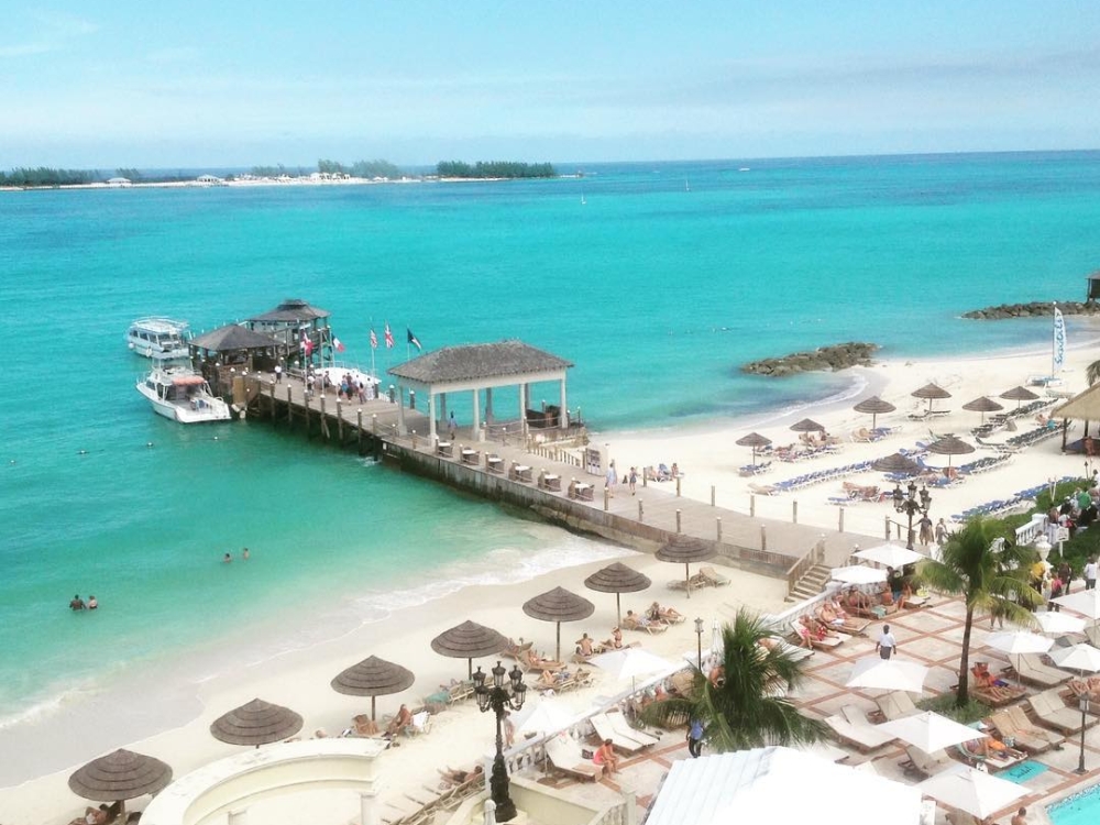 An aerial photo of the Sandals Royal Bahamian pier and offshore island.