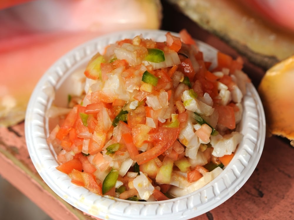 A close-up photo of a bowl of fresh conch salad.