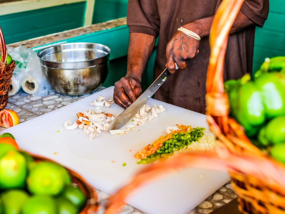 A chef chops fresh conch meat for conch salad in The Bahamas.