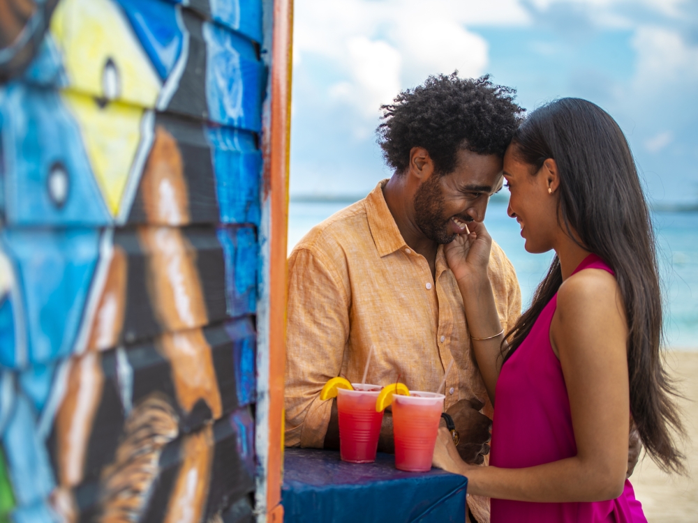 A couple embraces on Junkanoo beach in The Bahamas