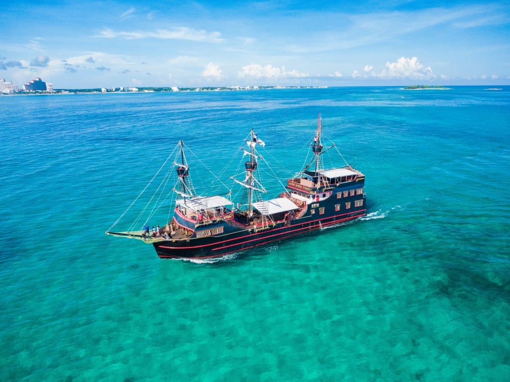 A pirate ship in the middle of turquoise waters