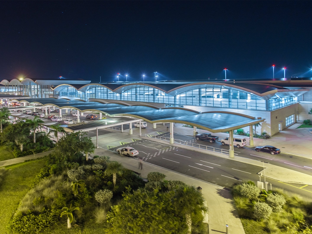 A lit up airport at night.