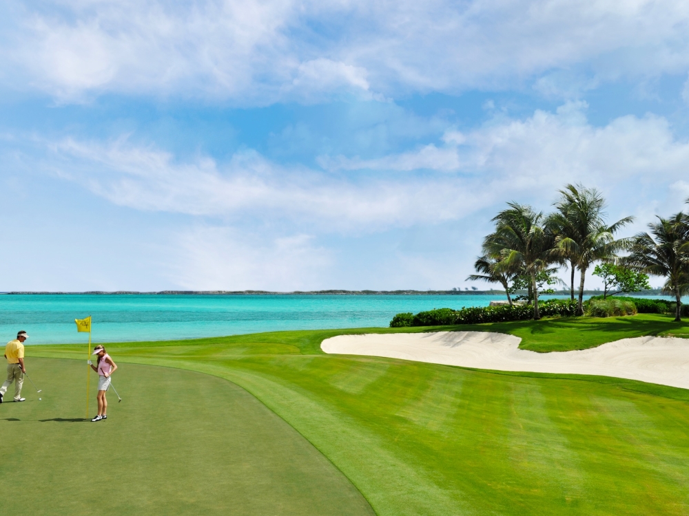 A couple on a golf green in Paradise Island, Bahamas