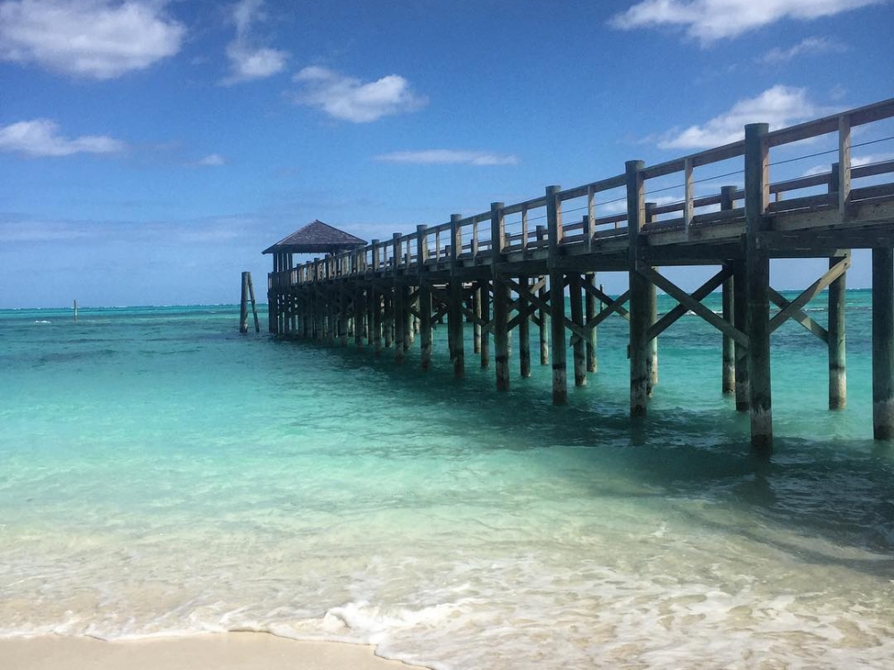A wharf extends into the turquoise waters at Cable Beach.