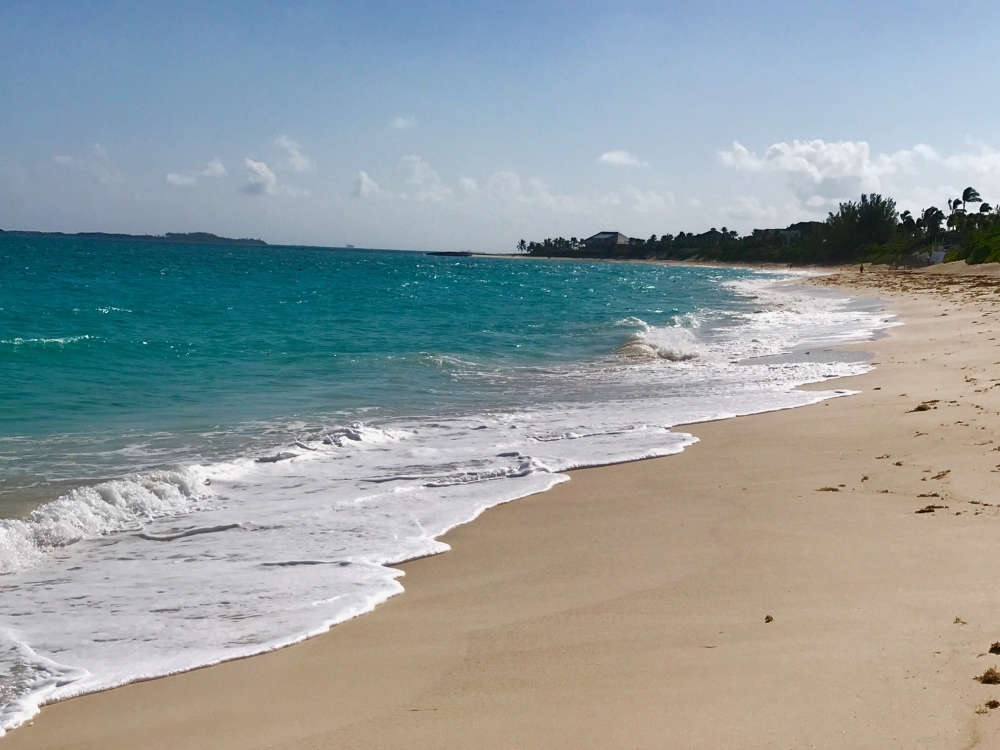 Bright turquoise waters lap ashore on Cabbage Beach in Paradise Island. 