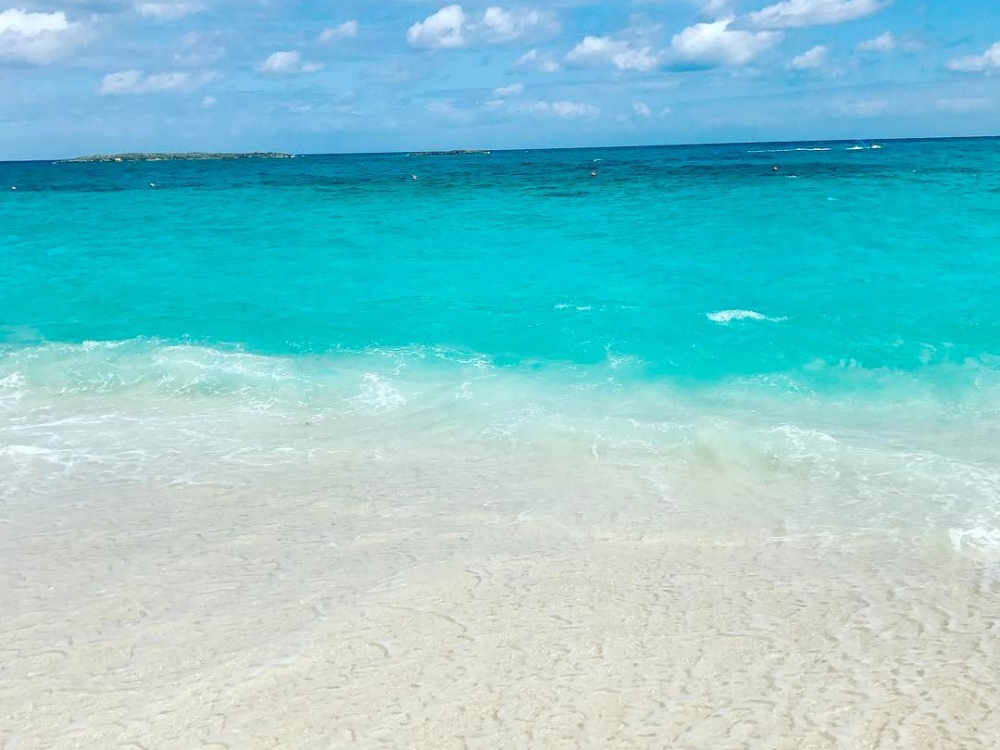 Waves wash on shore at Paradise Beach in The Bahamas.