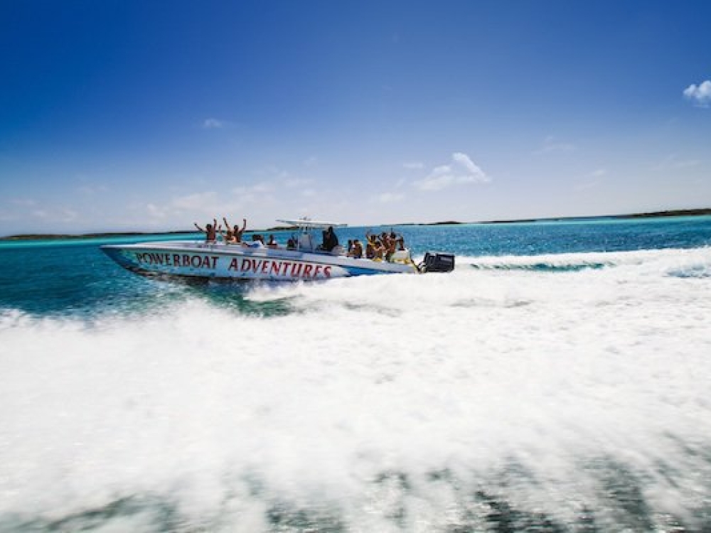 A Powerboat Adventures speed boat rides through the turquoise waters of The Bahamas. 