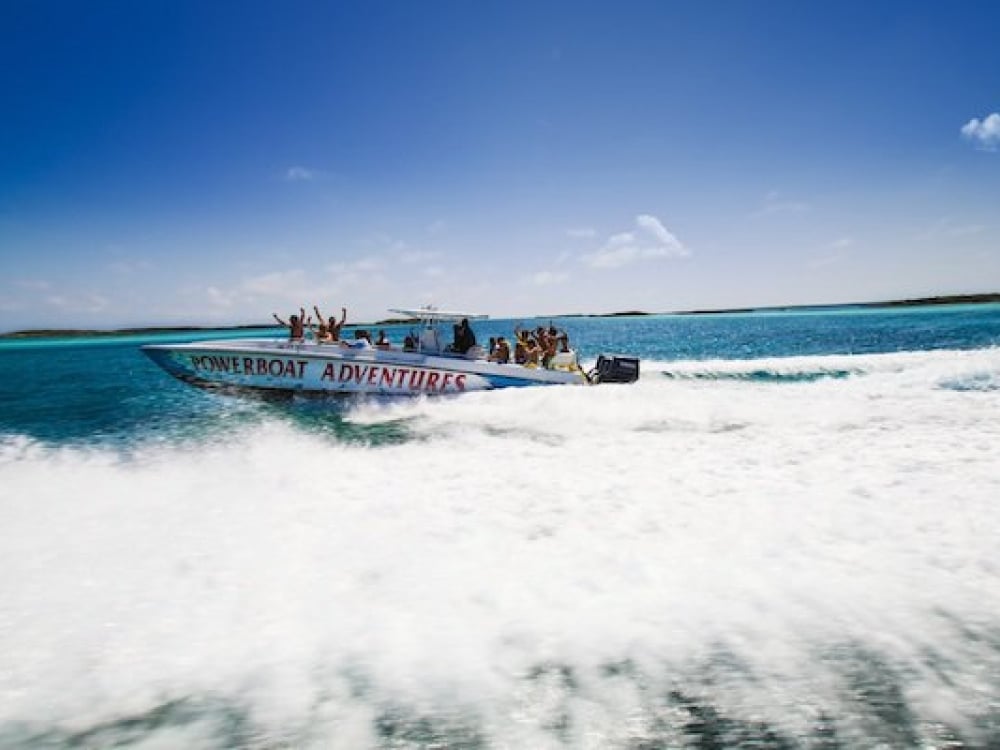 A Powerboat Adventures speed boat rides through the turquoise waters of The Bahamas.
