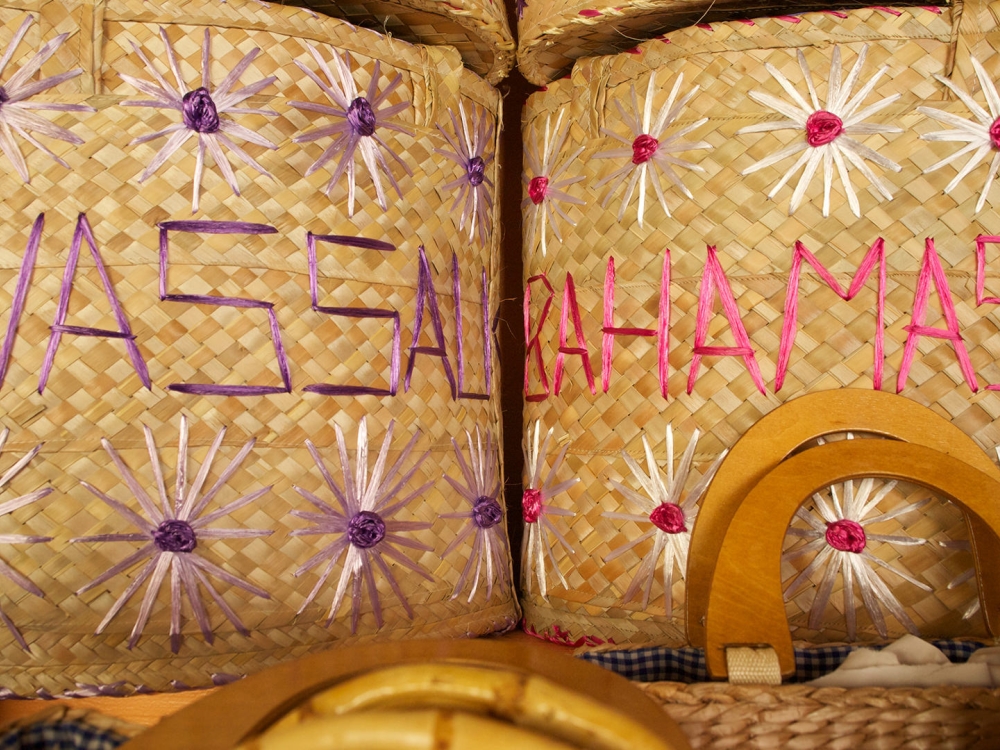 Hand woven straw baskets that read "Nassau" and "Bahamas".