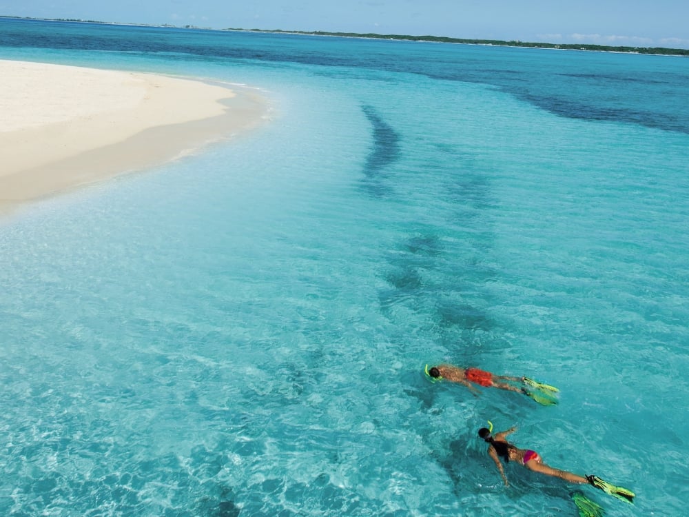 A couple snorkels in the crystal clear waters of Nassau Paradise Island