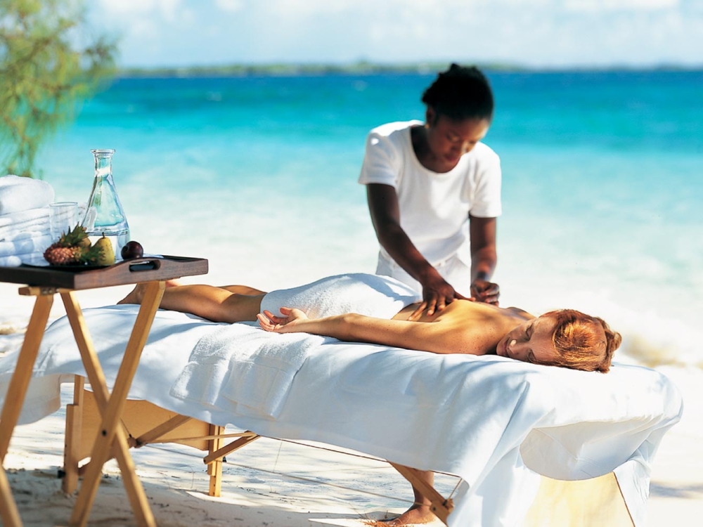 Woman receiving ocean-side massage