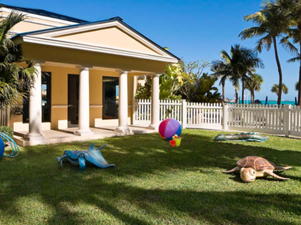 A bright, green lawn overlooking the beach.