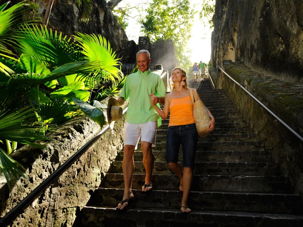 Couple walking down a sunlit staircase