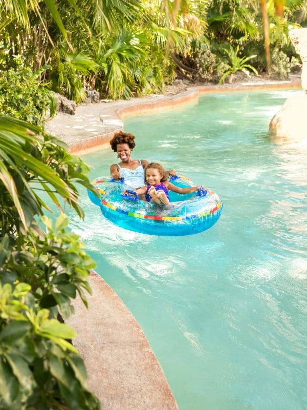 A mother and daughter tubing down a Lazy River at Atlantis